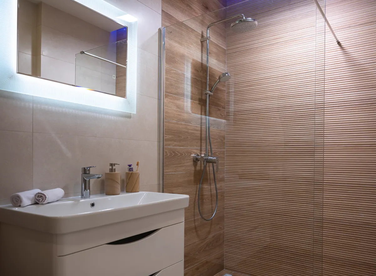 A bathroom with wood-effect tiles and a walk-in shower