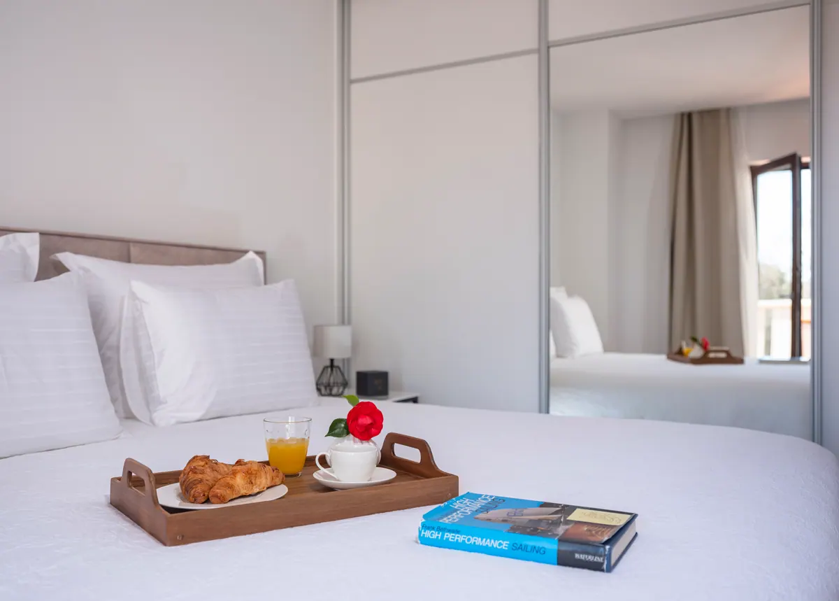Breakfast tray on white bed linen