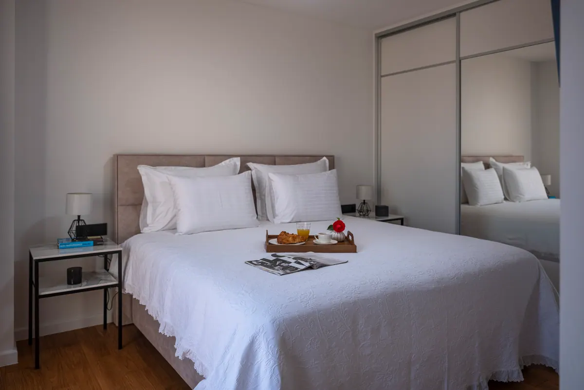 A king-size bed with a breakfast tray