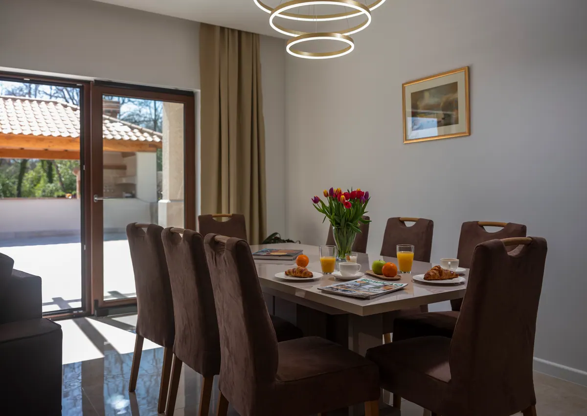 The dining table set for breakfast, with glass doors to the terrace