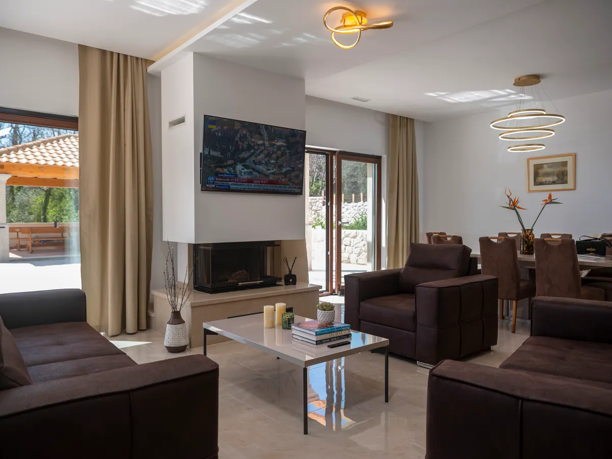 The lounge with sofas, Smart TV and doors to the terrace