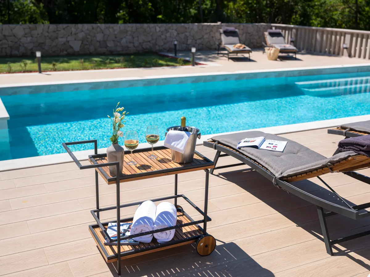 Wine and towels on a trolley beside the pool