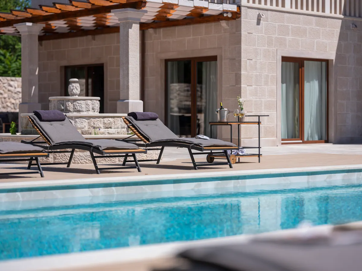 Loungers by the pool under the pergola